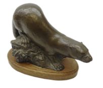 Bronze model of an Otter on a rocky base by Michael Rizzello, signed 'Rizello 2', on oval oak base,