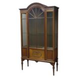 Edwardian mahogany display cabinet, stepped arch top with fluted frieze carved with flower heads,