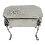 Edwardian silver dressing table jewellery box, the hinged lid embossed with Iris decoration,