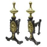 Pair of Adam style cast iron Fire dogs with brass spool finials and oval fan medallions on angular
