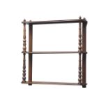 Edwardian mahogany three tier wall shelf, turned supports, W46cm,