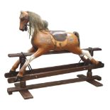 Carved wood and painted rocking horse on trestle base,
