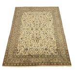 Persian Kashan carpet, ivory ground with blue interlacing overall design, repeating scroll border,