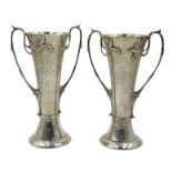 Two Art Nouveau beaten silver vases, floral design twin handles by Charles Edwards, London 1905/06,