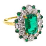 Oval emerald and diamond gold cluster ring, with emerald border hallmarked 18ct, emerald approx 1.
