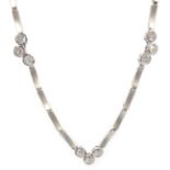 Brushed white gold necklace set with nine round brilliant cut diamonds,