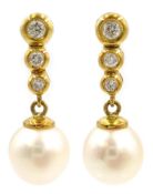 Pair of 18ct gold graduating three stone diamond and pearl pendant ear-rings,