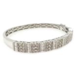 White gold baguette and round brilliant cut diamond hinged bangle, stamped K18, diamonds 2.