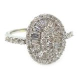 White gold diamond and baguette diamond mirror cluster ring, with diamond set shoulders,