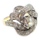 18ct gold diamond scroll ring, central old cut diamond approx 0.