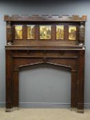Early 20th century oak fire surround, architectural form with crenel style cornice,