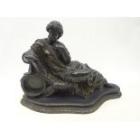 Bronzed Victorian style watch stand in the form of a reclining Goddess, on oval shaped plinth,