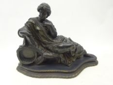 Bronzed Victorian style watch stand in the form of a reclining Goddess, on oval shaped plinth,