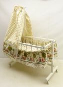 1960's dolls swinging cradle, upholstered in children's printed cotton fabric,