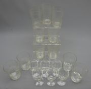 Set of four Edwardian etched glass beakers,