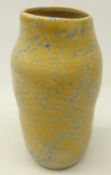 Ruskin vase of ribbed form, decorated in blue and yellow tonal mottled glaze, impressed 1927,