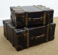 Graduating set of two leather and wooden bound trunks,