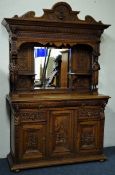 19th century continental oak bevel edged mirror back sideboard, projecting cornice,