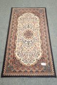 Persian blue ground rug, central medallion, beige floral field, repeating border,