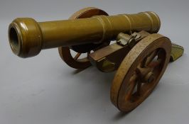 Bronze model cannon on brass mounted mahogany carriage with pair of metal rimmed eight-spoke wheels