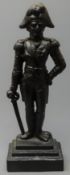 Cast iron fireside figure of Wellington depicted standing resting on his sword,