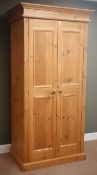 Solid pine double wardrobe enclosed by two panelled doors, W98cm, H197cm,