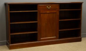 Early 20th century mahogany bookcase, adjustable open shelves flanking centre cupboard, plinth base,