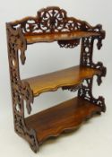 20th century walnut three tier wall shelf with fretwork carved galleries and cresting,