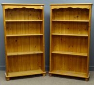 Two pine open bookcases, shaped frieze, three adjustable shelves, bun feet, W84cm, H151cm,