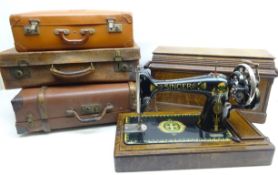 Singer Sewing machine in oak case and three vintage suit cases,