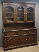 Traditional oak dresser, projecting dentil cornice, three stepped arched glazed doors