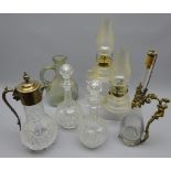 Early 20th century cut glass claret jug with silver-plated mount, pair faceted glass decanters,