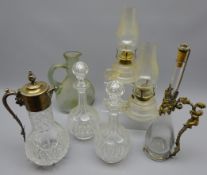 Early 20th century cut glass claret jug with silver-plated mount, pair faceted glass decanters,