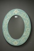 Blue oval framed mirror with floral pattern