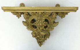 Rococo style gilt gesso wall bracket, shaped shelf above foliate scroll support,