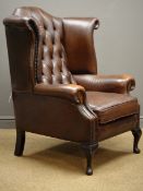 Georgian style wingback armchair, upholstered in brown deeply buttoned leather,
