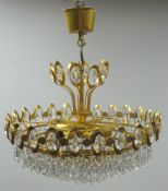 Gilt metal five light chandelier, four graduating circular tiers with teardrop shaped drops,