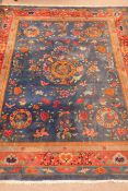 Large Chinese blue ground rug carpet, central dragon medallion, floral field, repeating border,
