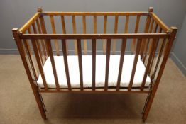 Early 20th century beech child's cot, with mattress, W122cm, H116cm,