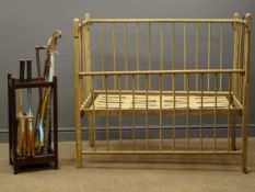 Early 20th century beech cot and an umbrella rack with three walking sticks,