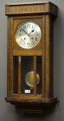 Early 20th century oak cased wall clock, silvered Arabic dial, twin train movement chiming on rods,