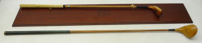 Auchterlonies of St Andrews hickory shafted golf club on wall mounted display stand with engraved