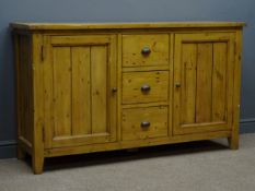Polished pine sideboard, three drawers flanked by two cupboards, W155cm, H90cm,