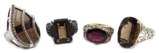 Two silver smoky quartz rings and two other stone set rings (5) Condition Report