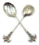 Pair of silver spoons with caduceus terminals and scalloped edging around bowl, James Deakin & Sons,
