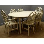 Painted circular extending dining table, turned supports, one leaf and six wheel back chairs (4+2),