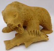 Carved softwood model of a bear with salmon catch,