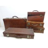 Collection of early 20th century suitcases, travel trunk and briefcase, two having H.W.