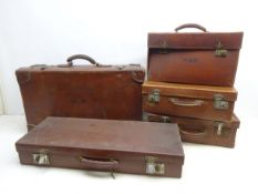 Collection of early 20th century suitcases, travel trunk and briefcase, two having H.W.
