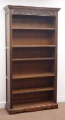20th century Old Charm oak open bookcase, projecting cornice, five shelves, shaped plinth base,